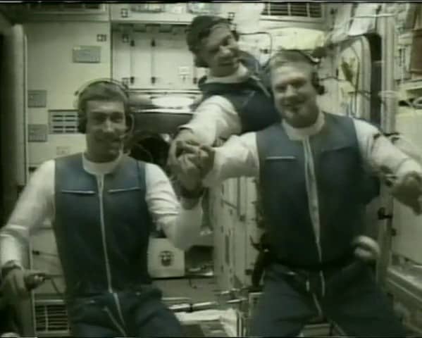 Expedition 1 crew of Sergei K. Krikalev, left, Yuri P. Gidzenko, and William M. Shepherd talking to the Flight Control Center in Korolev, Russia, outside of Moscow, from the International Space Station’s Zvezda Service Module
