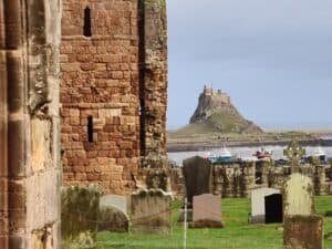 Prior ruins, cemetary and Castle in the far distance at Lindisfarne. Image: 360onhistory.com