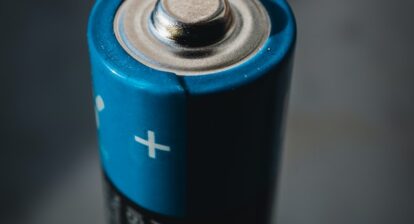 A blue and black double A battery. Photo by Mika Baumeister on Unsplash