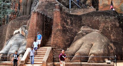 Stairs going upwards into two gigantic stone feet on either side. From Sri Lanka