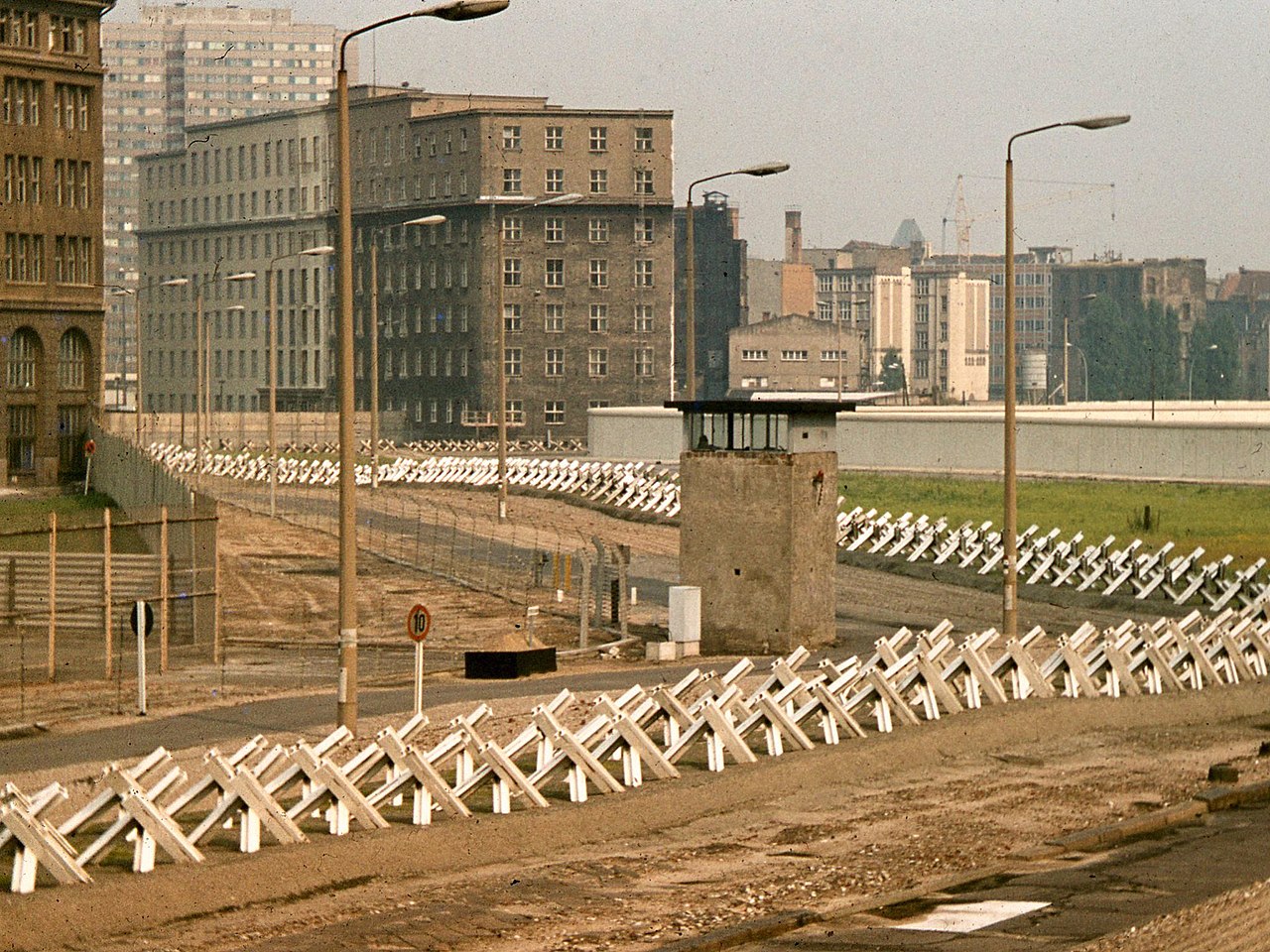 Berlin Wall death strip, 1977, showing Czech hedgehog and guard tower.