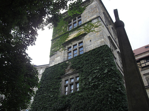 The window (top floor) where the defenestration occurred. A monument stands to the right of the castle tower.