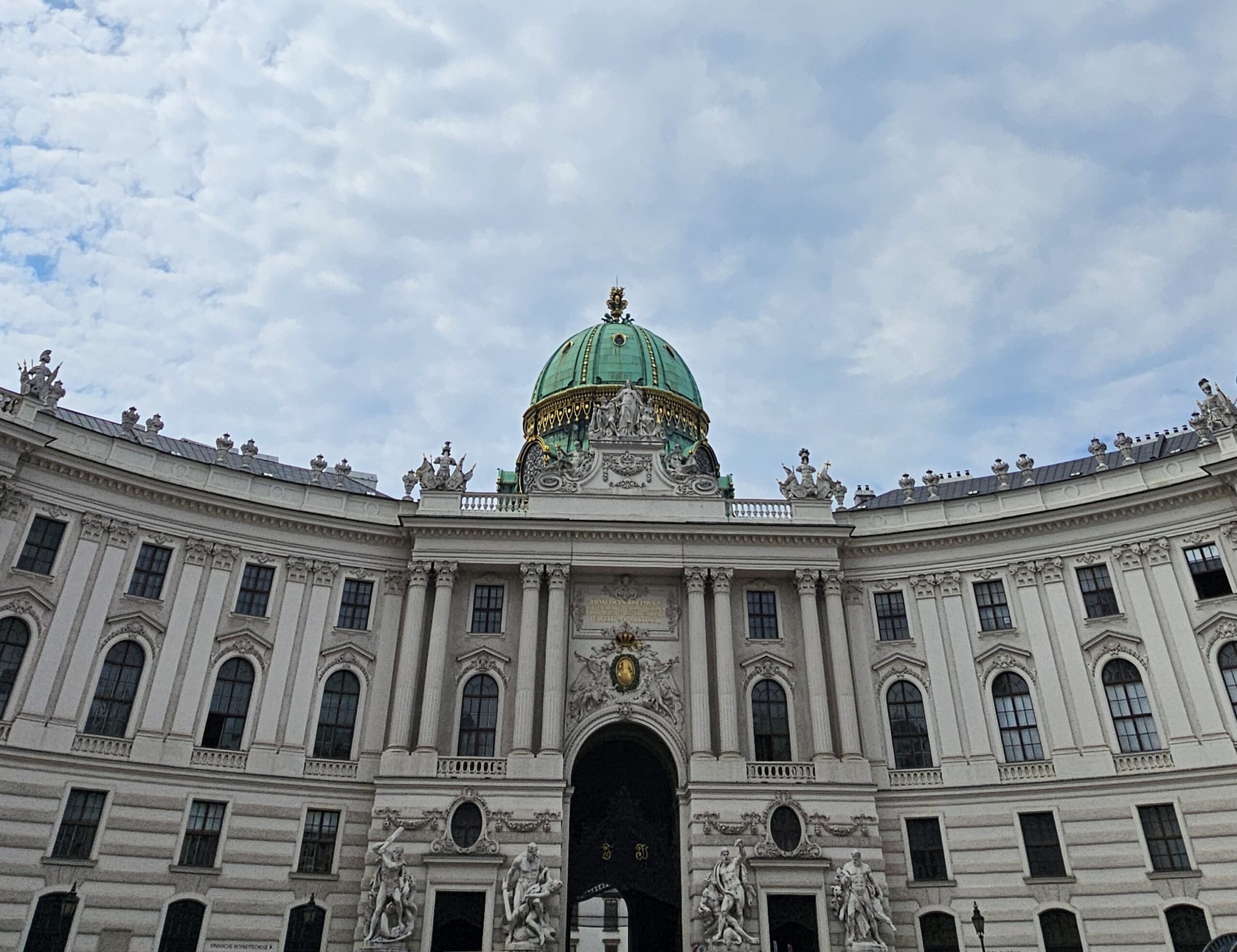 Hofburg Vienna, St Michael entrance. It has a green dome with gold work on it.