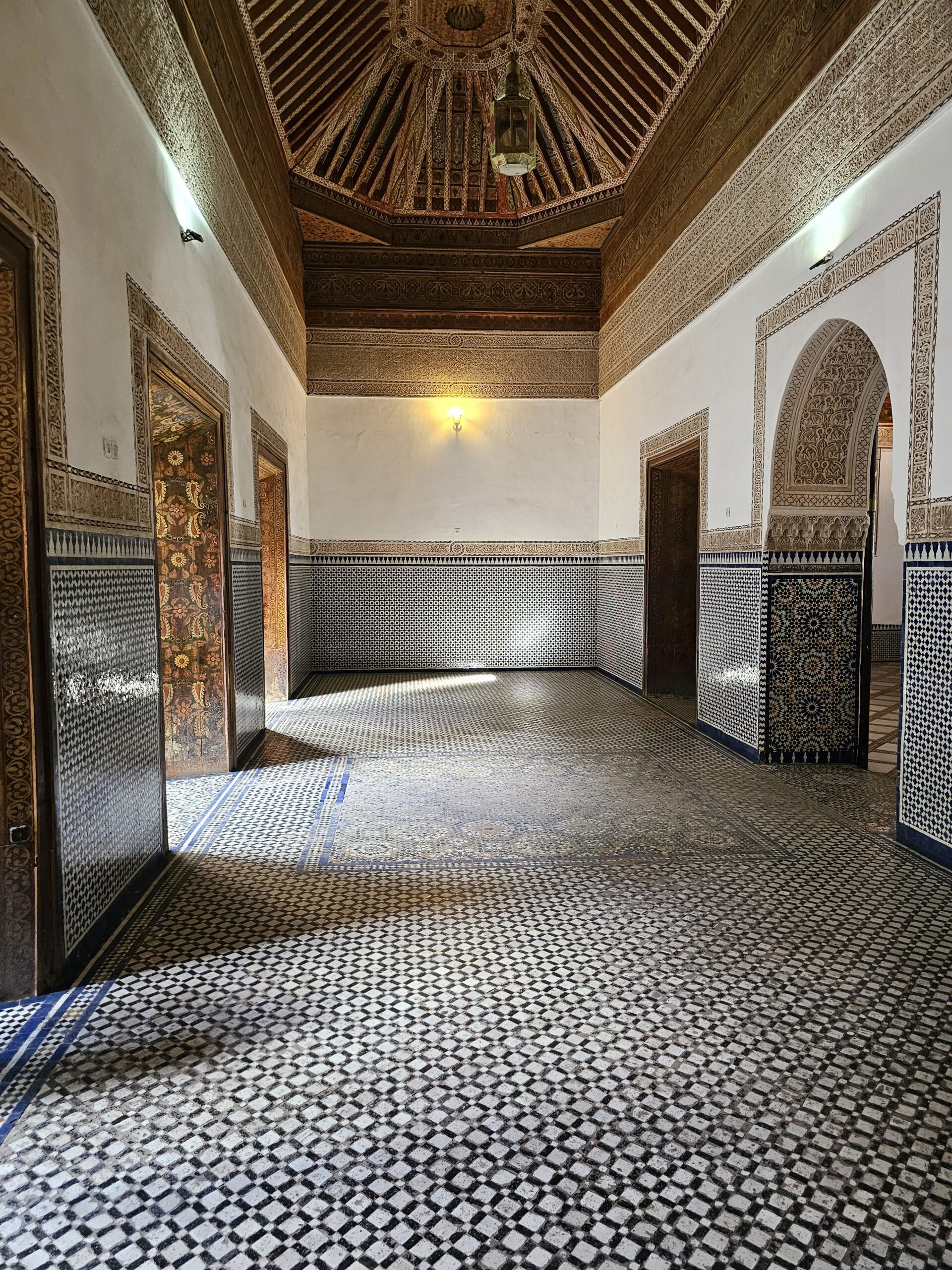 A corridor at Bahia Palace, Marrakesh. The floor is colourfully tiled. Image by 360onhistory.com