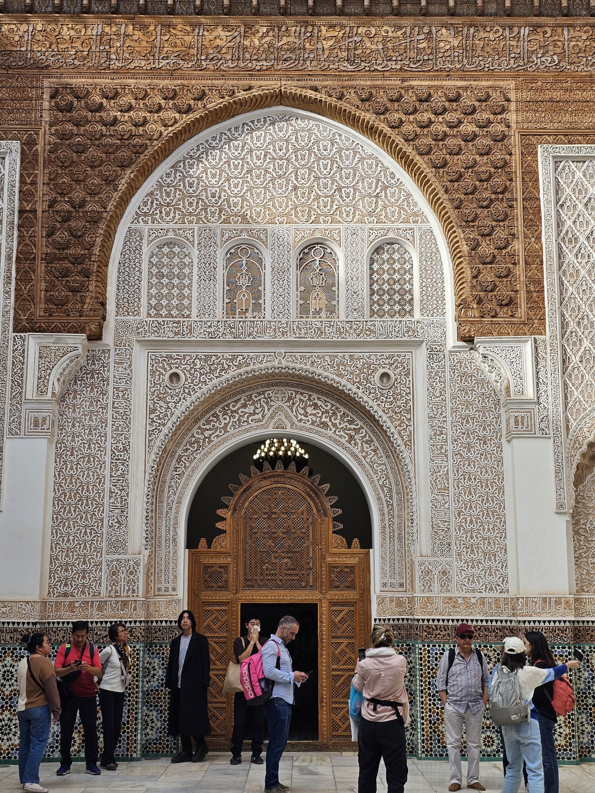 A gorgeously carved wooden wall with door at Ben Youssef Madrasa, Narrakesh. Image by 360onhistory.com