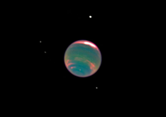 Combined colour and near-infrared image of Neptune, showing bands of methane in its atmosphere, and four of its moons, Proteus, Larissa, Galatea, and Despina